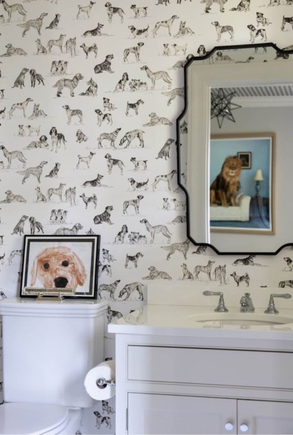 A bathroom interior designed by Andrea Sinkin and photographed by Lo Austin Photo utilizing black and white dog wallpaper to showcase the animalcore design trend in any room in your home.