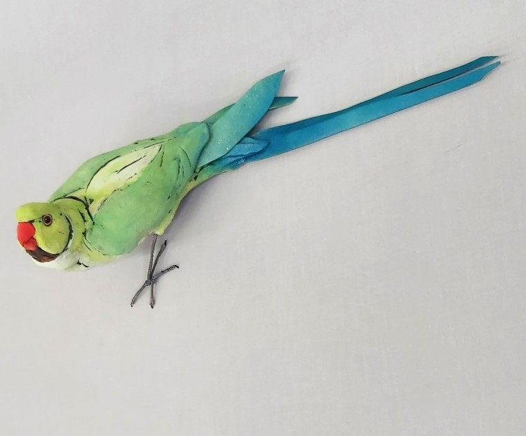 A ceramic parrot displayed on the wall created by James Ort.