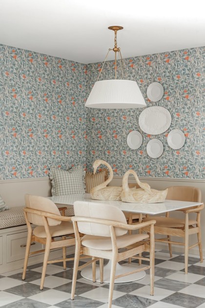 White wooden swans on a kitchen table as a center piece to the room designed by Rebecca Gibbs Design + Build.