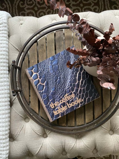 A faux snake skin coffee table book that exemplifies the animalcore design trend from The Coffee Table Book.