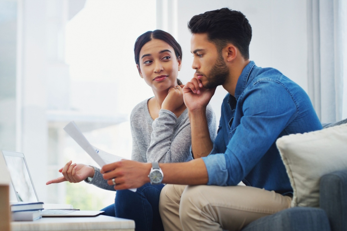 Man and woman discuss the process of digitizing their home sale paperwork 