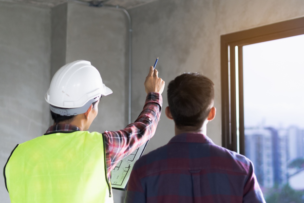 Home inspector walks a potential buyer through a home