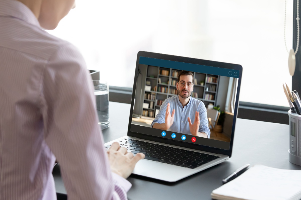 Man talks with a real estate professional in a video call about the process of closing his home remotely 