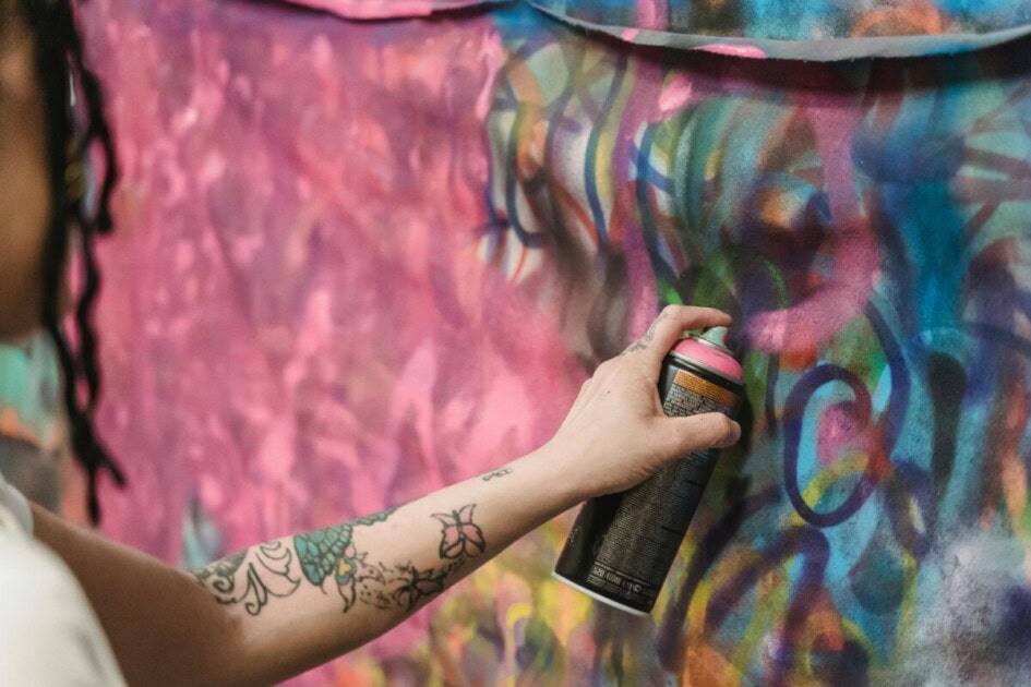 Hand spray painting the wall