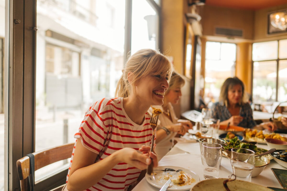 A young woman eating in a restaurant