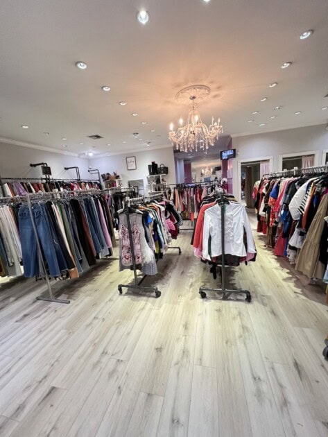 Inside clothing boutique with clothes on the rack