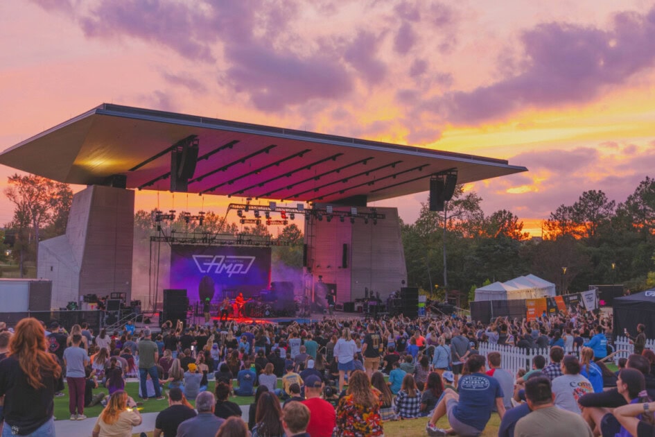 Photo of outdoor theater and people in the crowd watching a performer