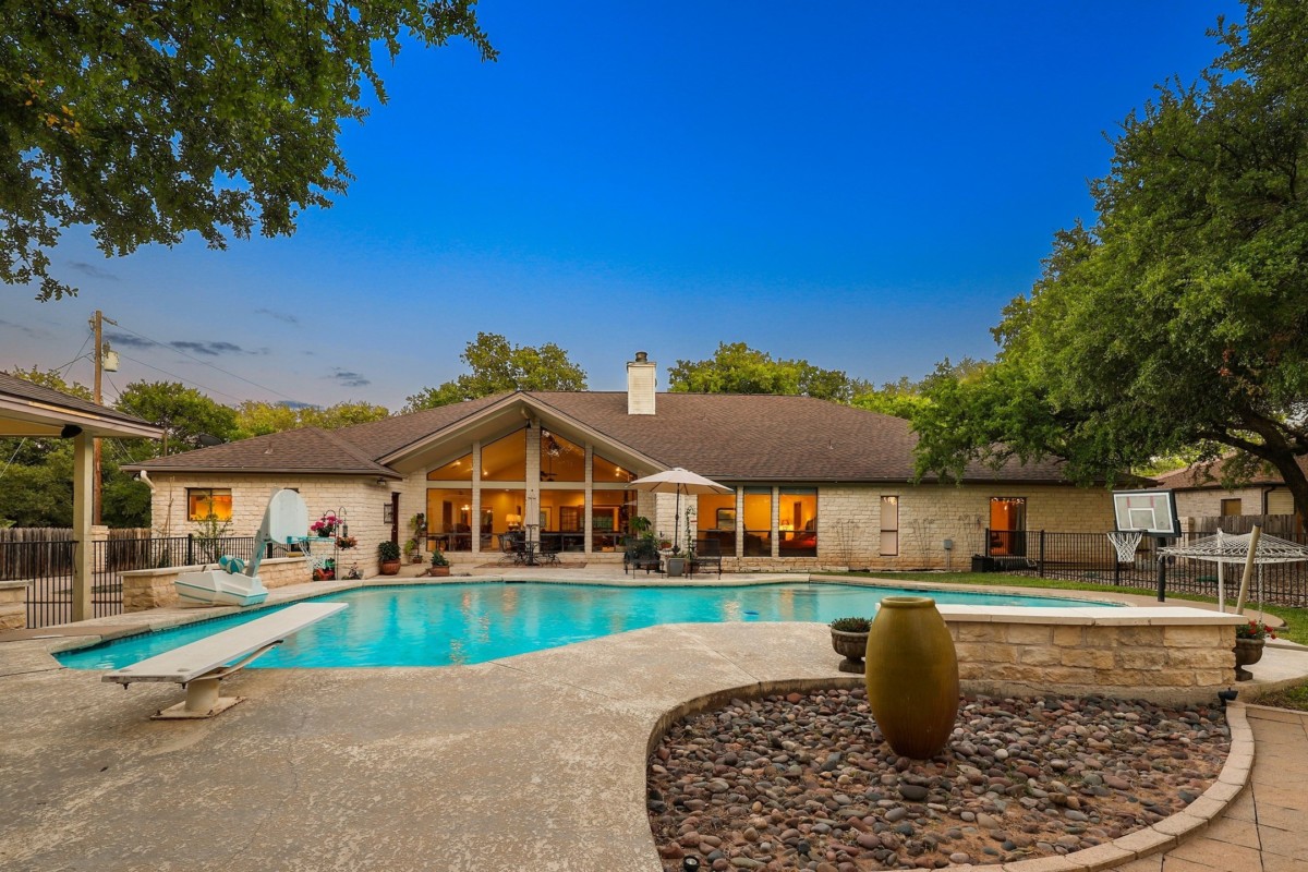 ranch style texas home with large yard and pool