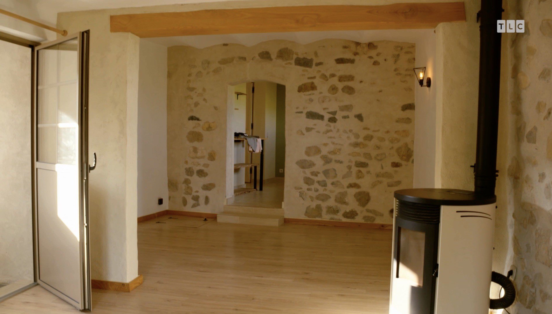 The existing aesthetic also includes a corner stove fireplace.