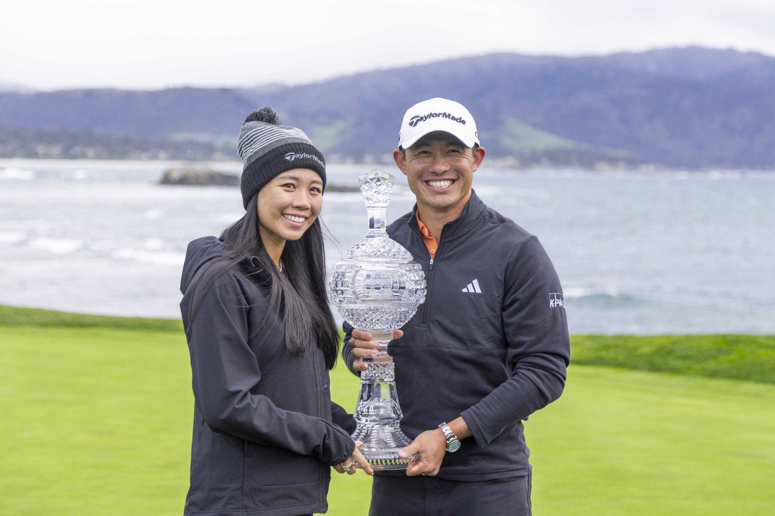 Collin Morikawa of the United States and his wife Katherine Zhu holding the trophy on hole #18 during the final round of the AT&T Pebble Beach Pro-Am 2026 at Pebble Beach