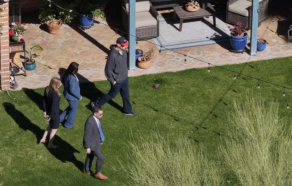 In an aerial view, law enforcement officials visit the backyard of Nancy Guthrie's residence