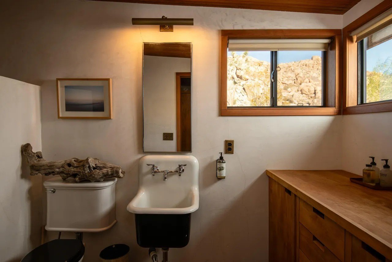 The indoor bathroom makes fine use of vintage pieces mixed with natural wood.