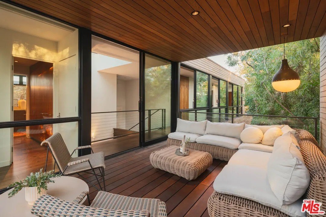 This covered, outdoor deck provides additional gathering/thinking/relaxing space.
