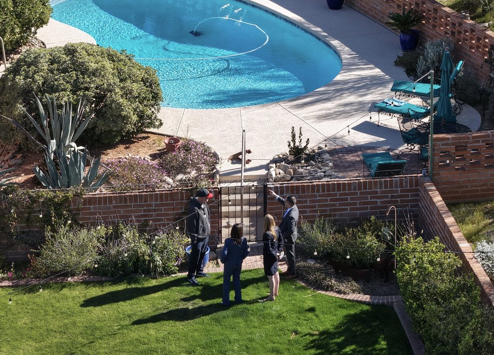 In an aerial view, law enforcement officials visit the backyard of Nancy Guthrie's residence
