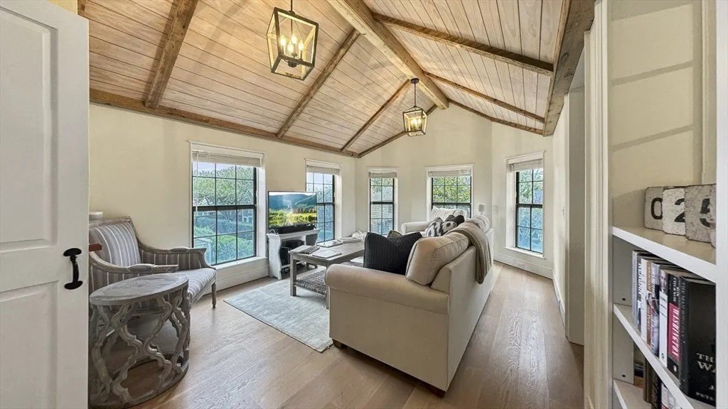 Now the living room features ceilings clad with wood repurposed from other parts of the house.