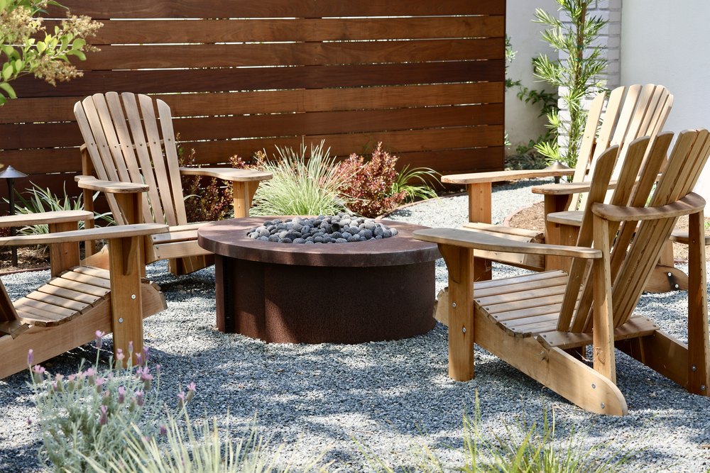 Fire pit nestled in someone's gravel based yard.