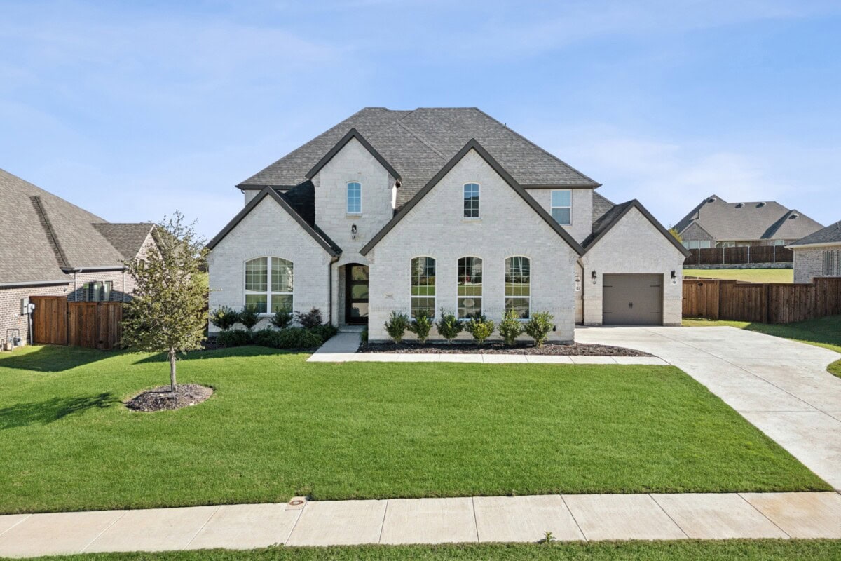 beautiful white brick home with black accents