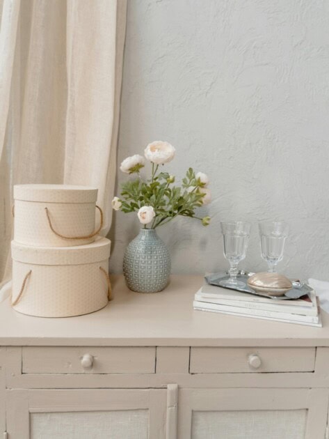 Using books as decorations on a bedside table with flowers