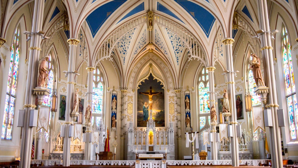 interior of a gothic church with lots of stained glass windows