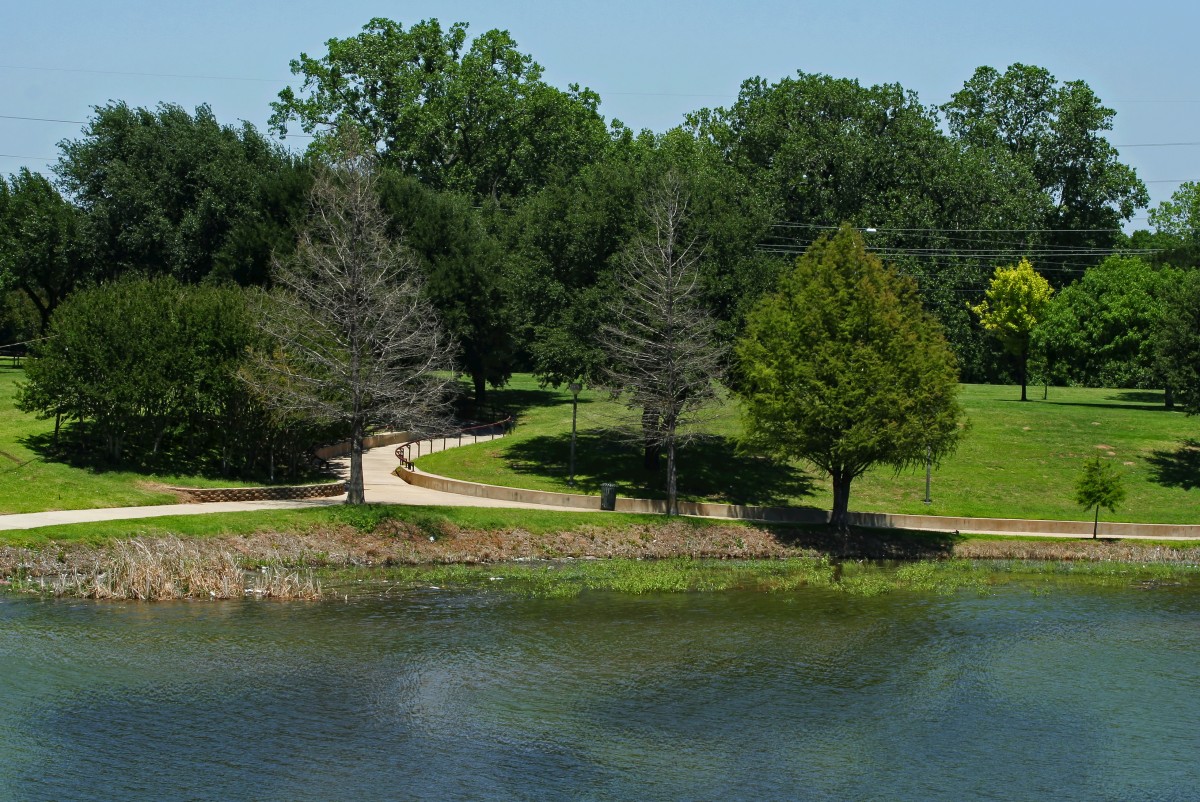 brazos river with park near suspension bridge in waco, texas, united states