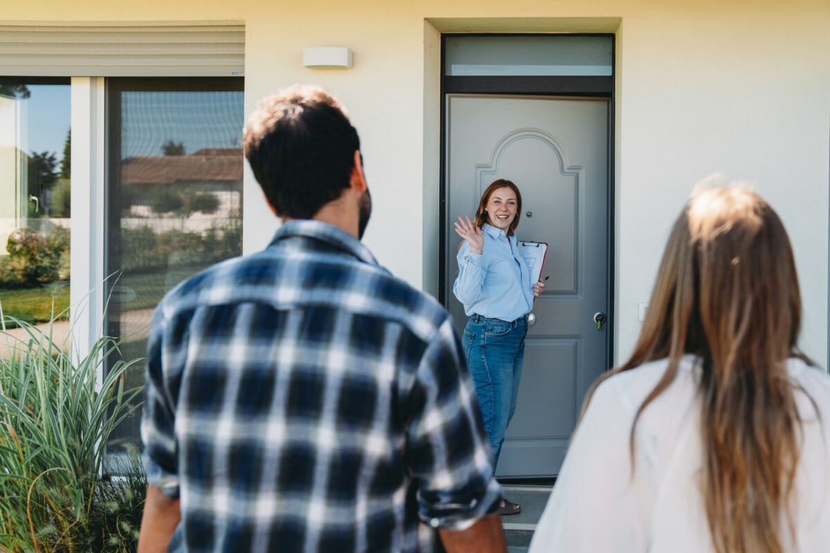 A real estate agent is showing an house to a couple