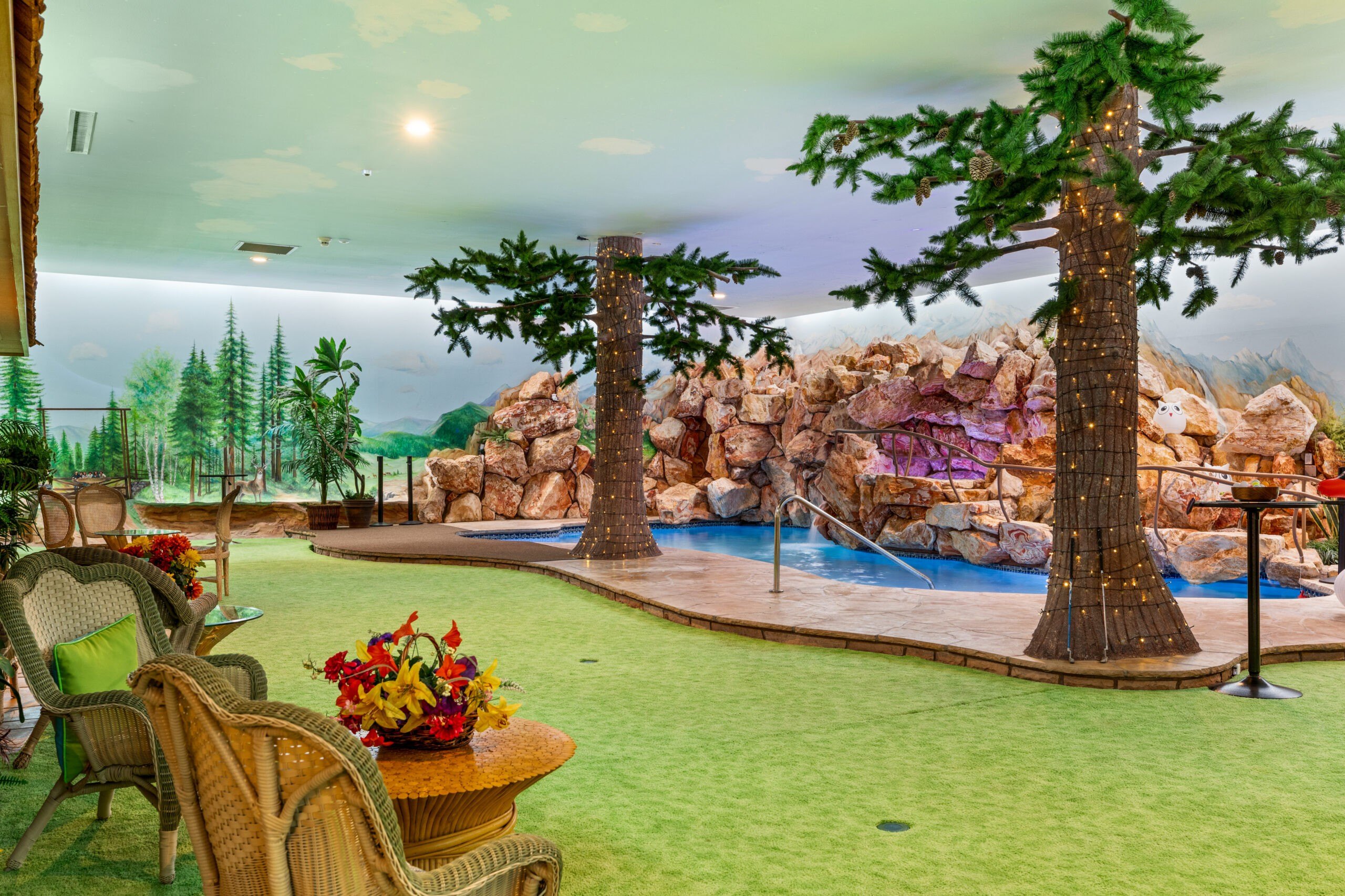 An underground backyard area featuring a pool and fake trees. Credit: Rooted Elements Media 