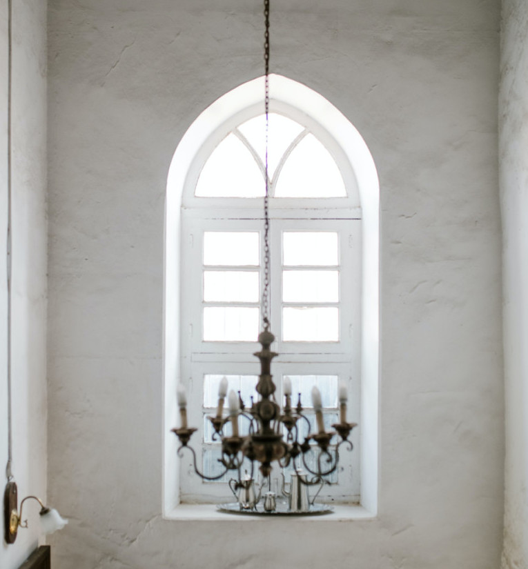 Chandelier in a room with an arched window