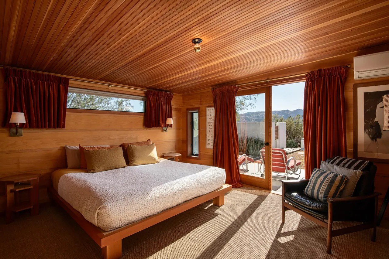 The primary bedroom has sliders that open to the great outdoors.