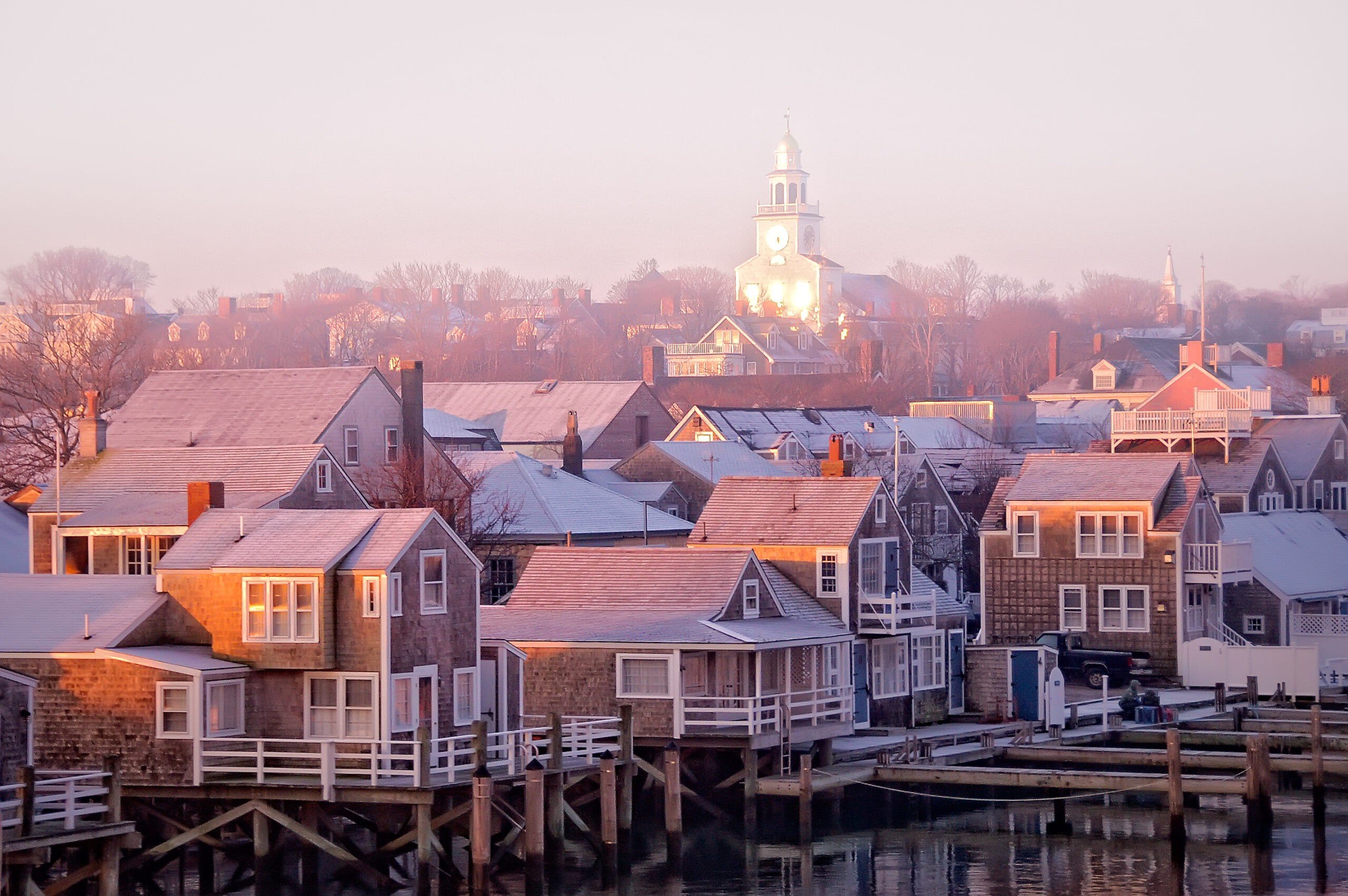 Nantucket town at sunrise in the fog.