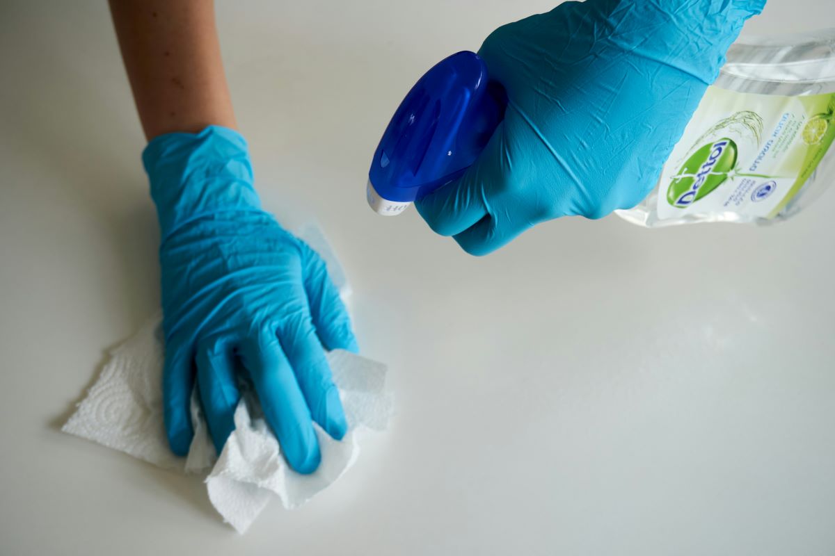 wiping down countertop with paper towel