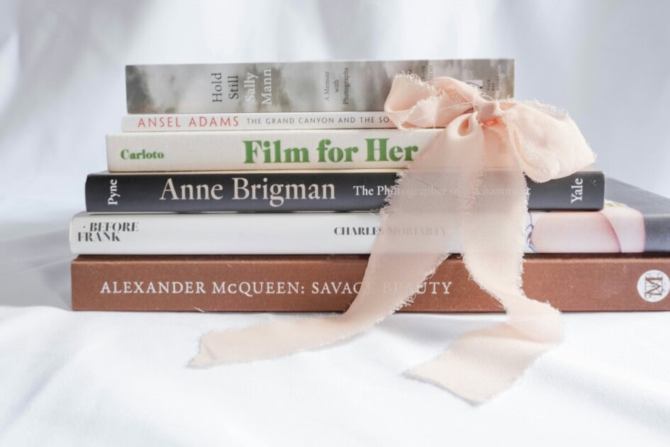 coffee table books stacked with a bow