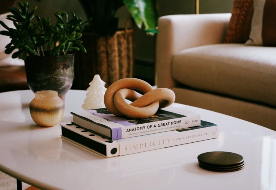 coffee table books being used as a riser for a decorative tabletop piece