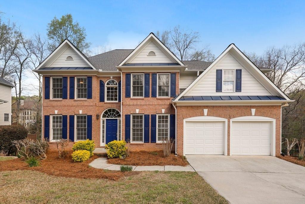 colonial home with garage and blue shutters