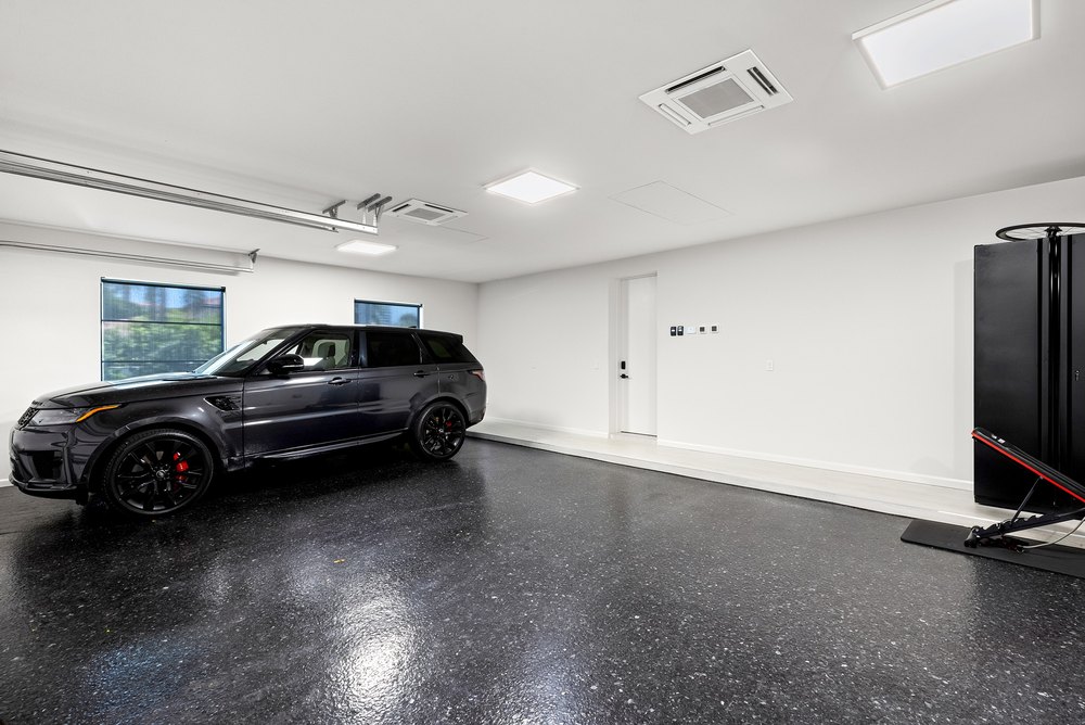 Spacious Garage Interior with Epoxy Flooring and Recessed Ceiling Lights