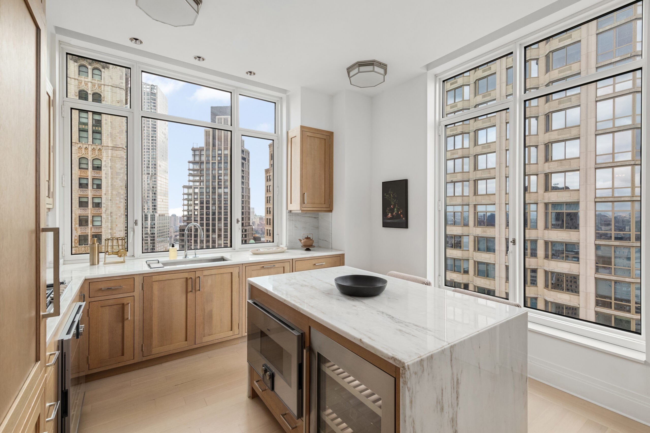 A kitchen with wooden cabinets and views of New York City in the Four Season Duplex in Manhattan New York