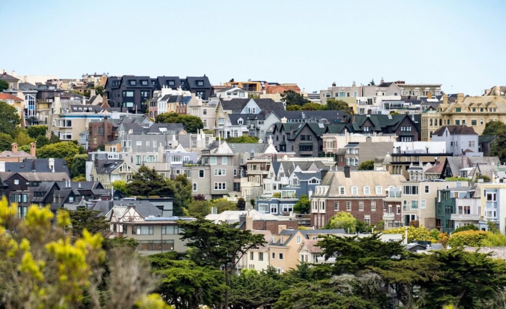 Several colorful houses sit on a hill in San Francisco