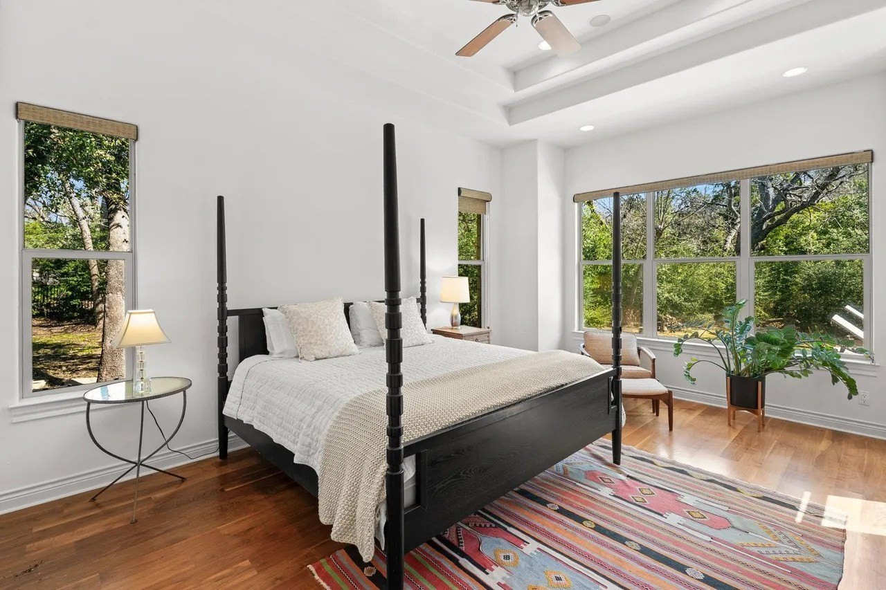 Bedroom with a black bed in a home in Austin Texas that belongs to Tate Donovan