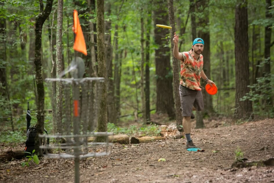 Man in the woods playing disc golf