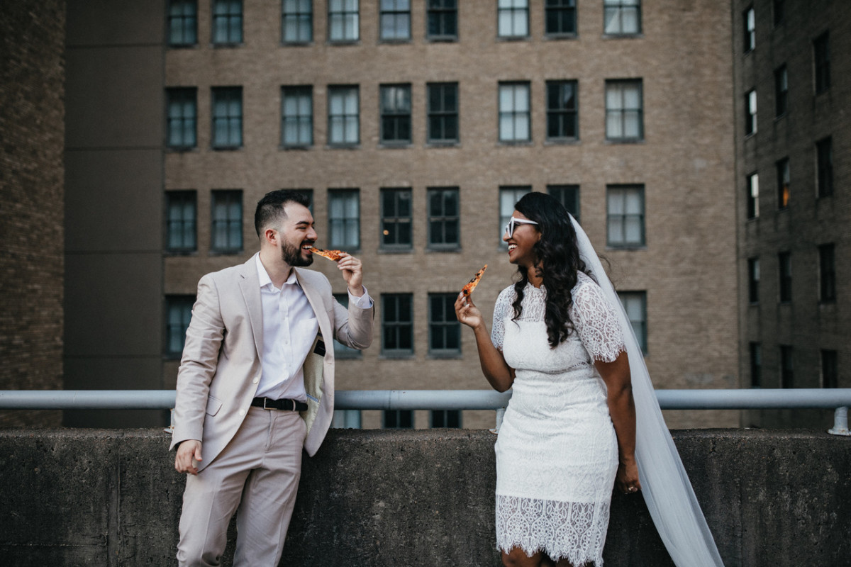 Couple eating pizza on the roof