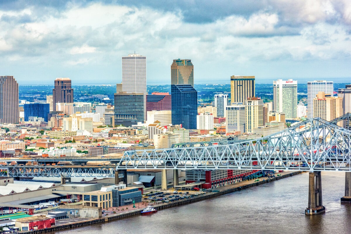 downtown new orleans skyline with clouds and river_Getty