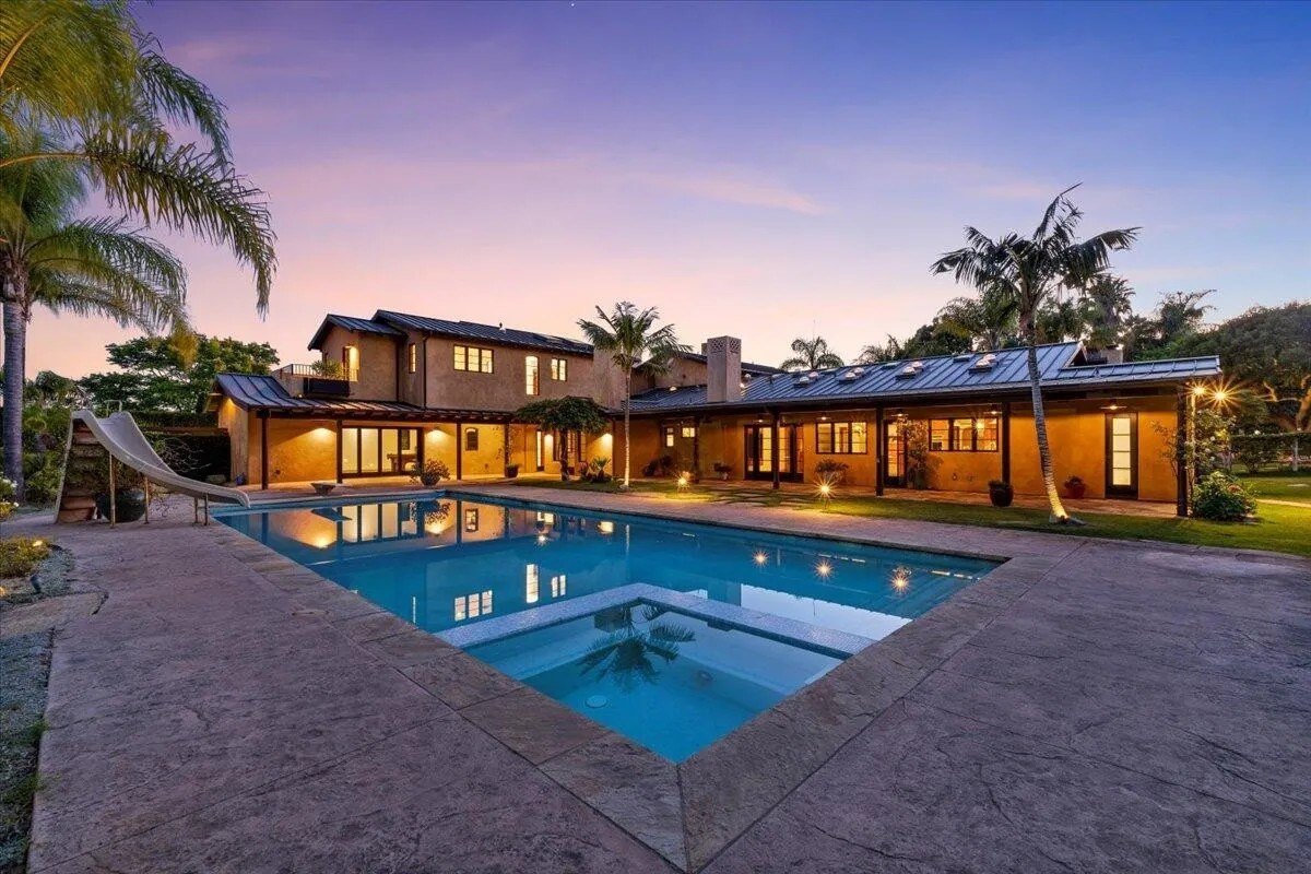 An oversized saltwater pool with a spa is but one of the backyard's many enticements.