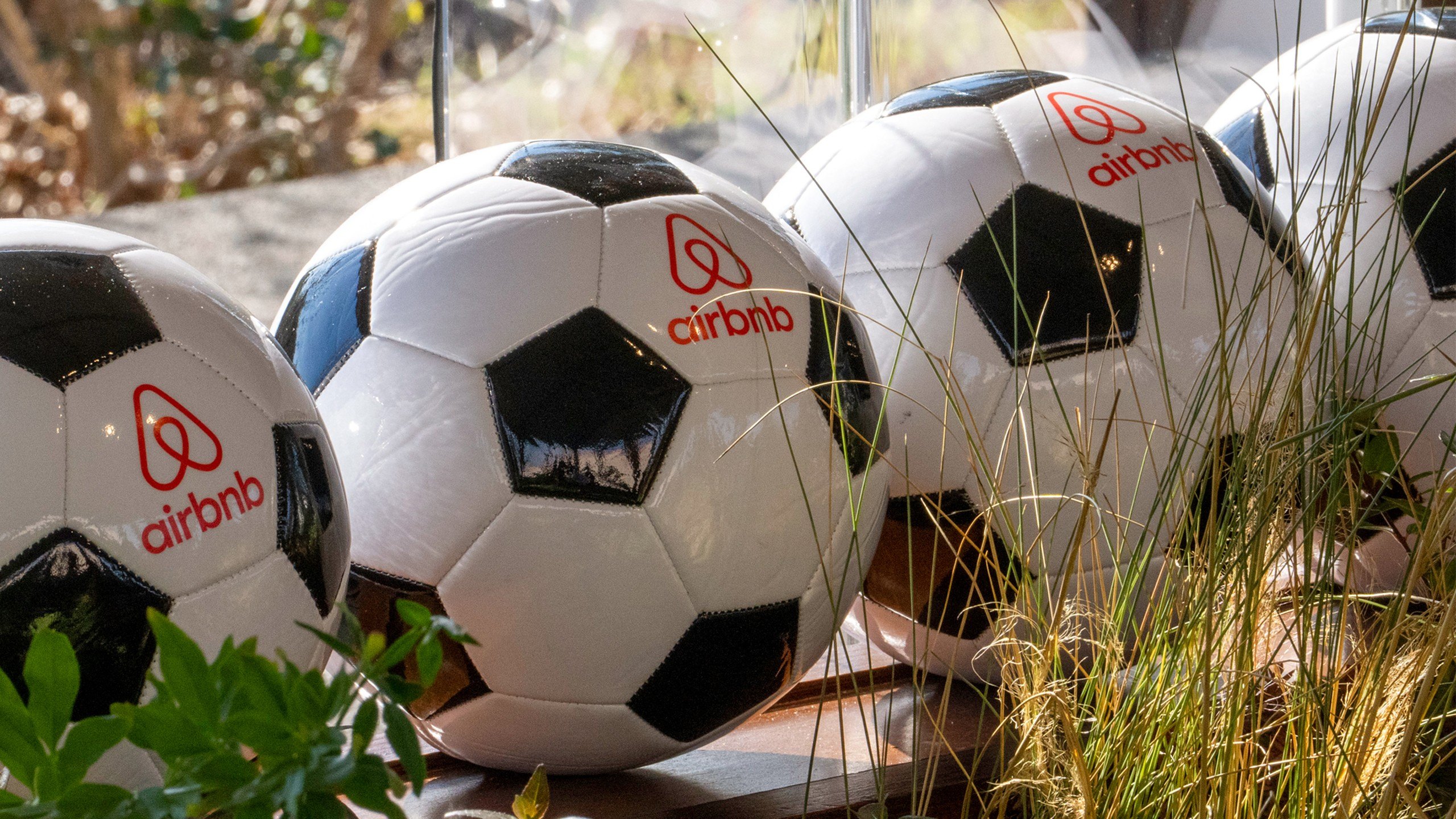 A photo of soccer balls with an Airbnb logo on them