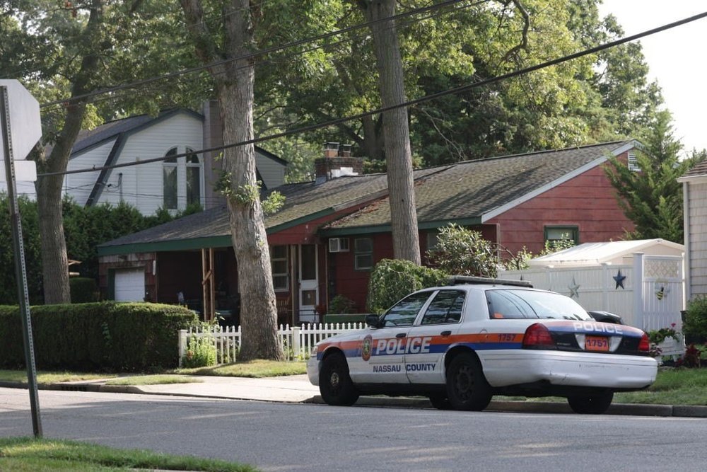 Massapequa Park, N.Y.: Nassau County police car is parked on First Avenue in Massapequa Park, outside the home of alleged killer of three sex workers in the Gilgo Beach case, Rex Heuermann, on July 26, 2023. (Photo by James Carbone/Newsday RM via Getty Images)