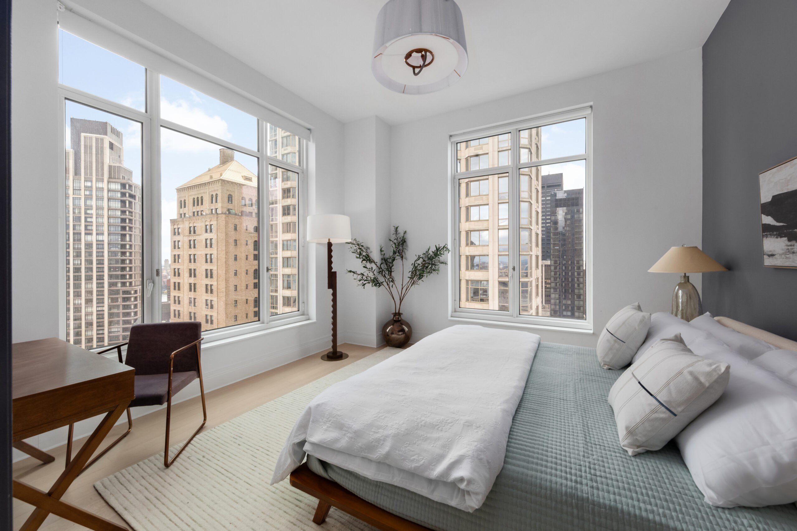 A bedroom with city views in the Four Season Duplex in Manhattan New York