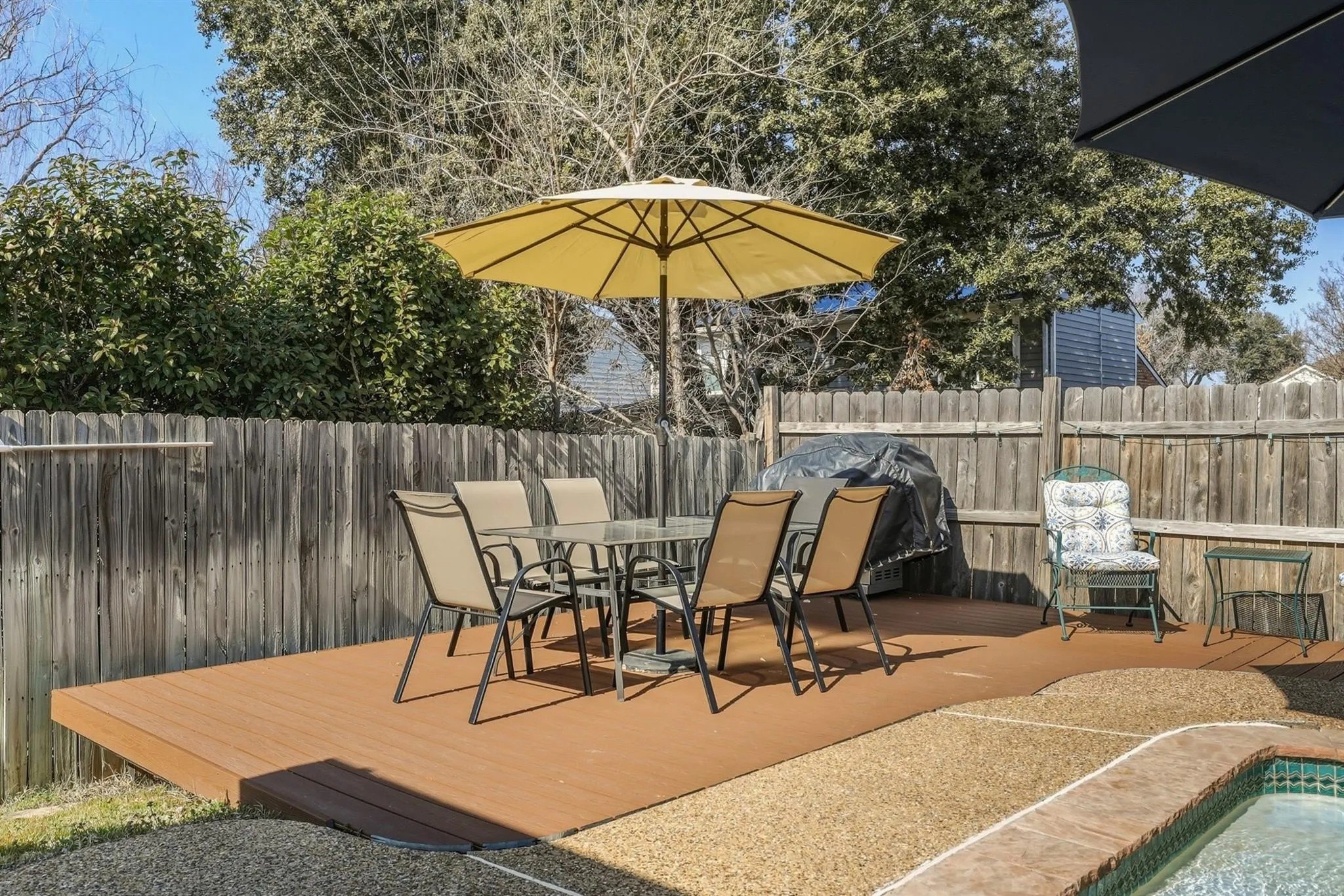 A patio table with a yellow umbrella at Post Malones childhood home