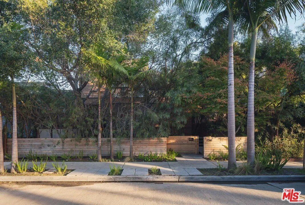 Discreet from the street, this home's mature foliage provides provides both shade and privacy.