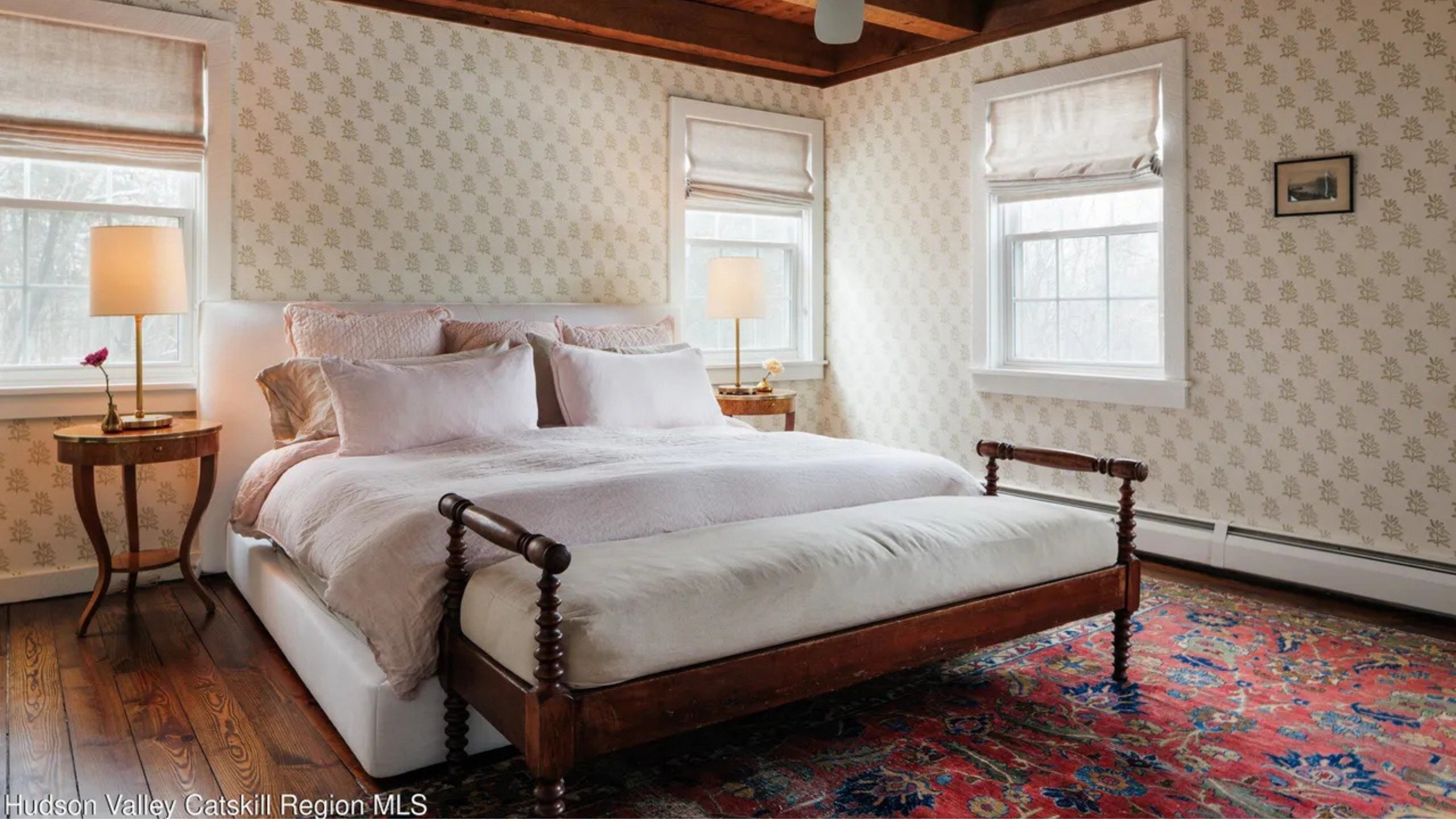 A bedroom staged with timeless furniture.