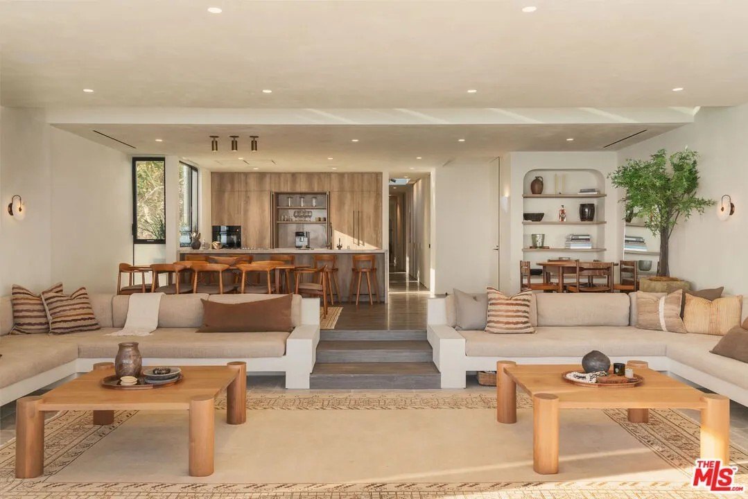 Open layout of kitchen and sunken living space in a luxury home in Malibu owned by Gal Gadot