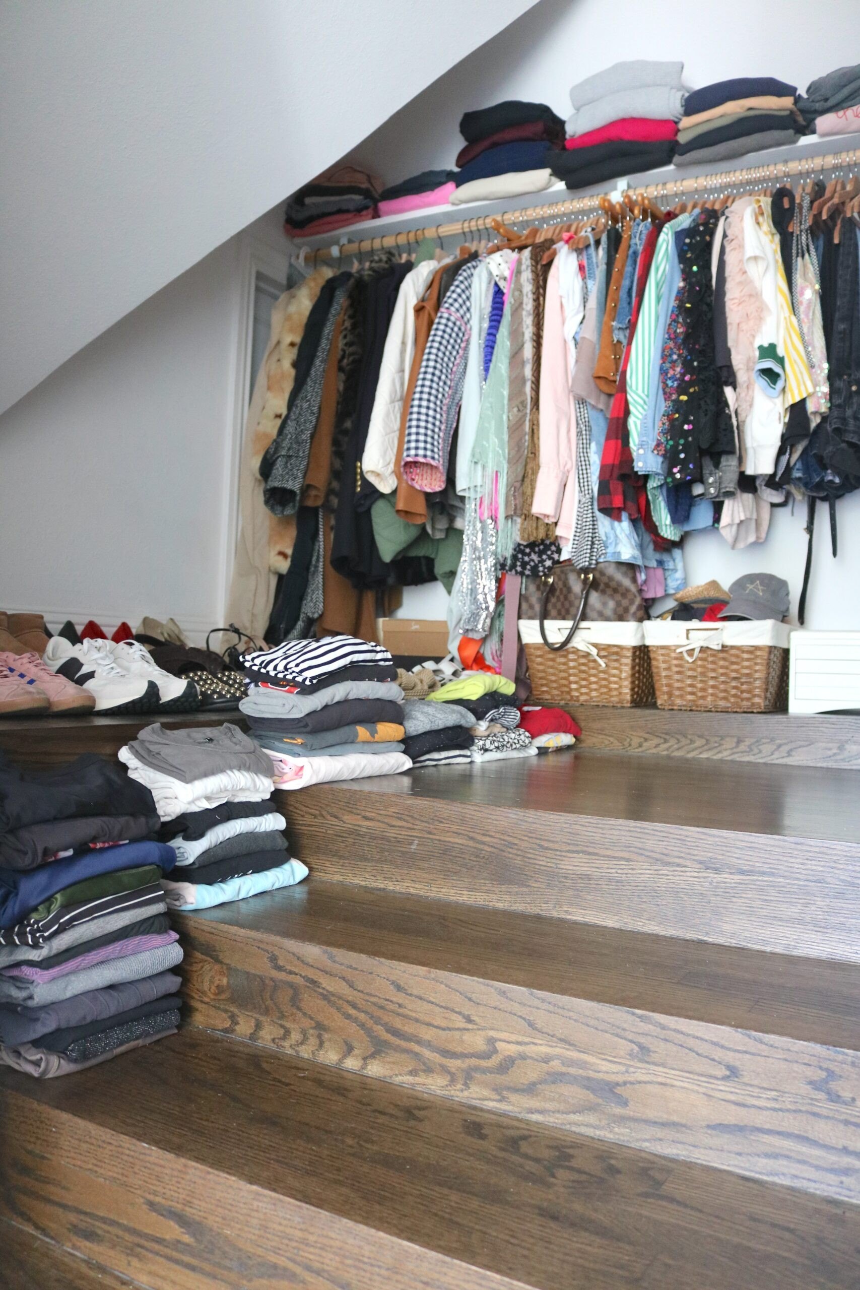 Storing much of my wardrobe on the steps of my walk-in closet lets me figure out the optimal configuration for a custom closet system before committing to the investment.