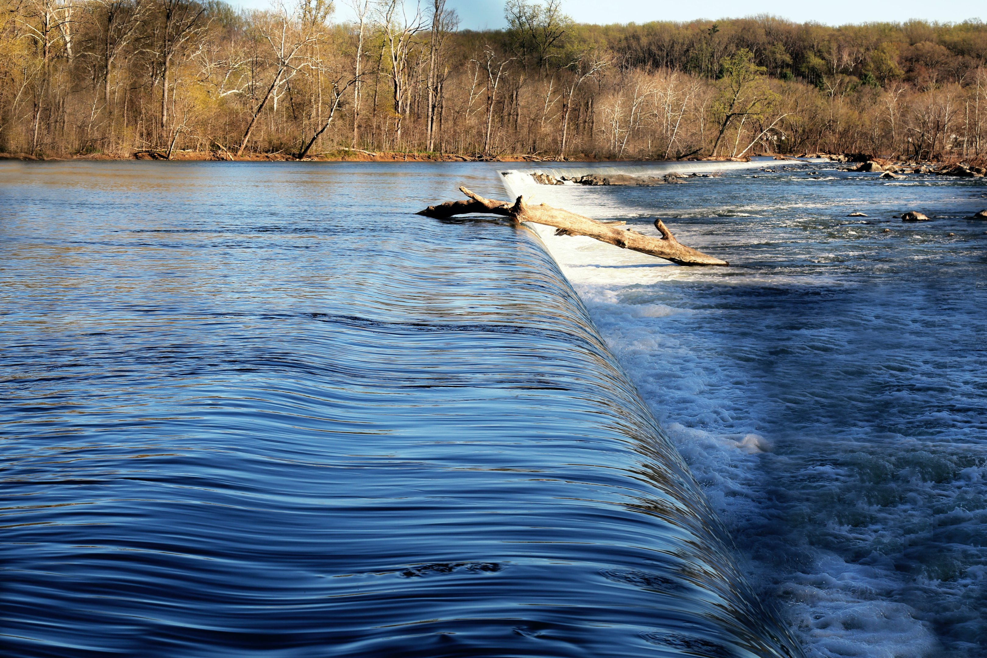 Brown wooden log on the river aqueduct 